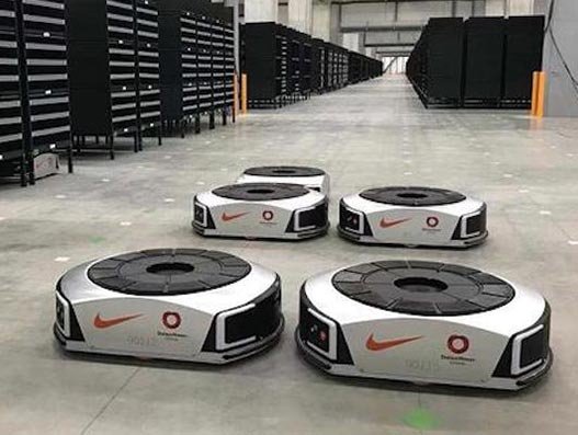 The smart robots carry Nike products and packages directly to the warehouse worker, reducing costs Logistics